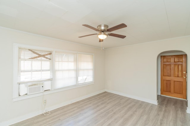 empty room featuring crown molding, light hardwood / wood-style flooring, and a healthy amount of sunlight