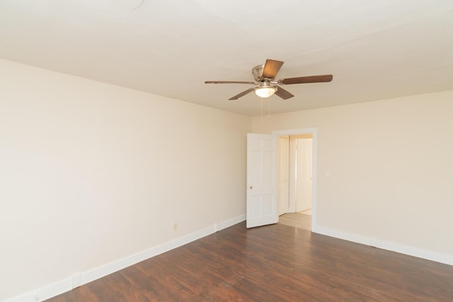 spare room featuring dark wood-type flooring and ceiling fan