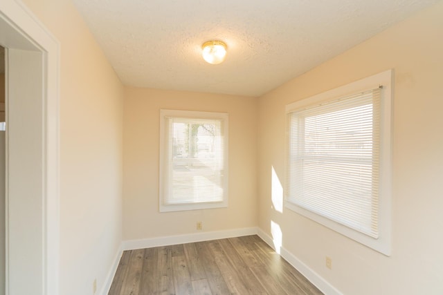 empty room featuring hardwood / wood-style floors and a textured ceiling