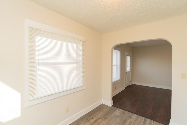 foyer with dark hardwood / wood-style floors and a textured ceiling