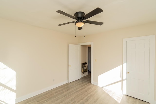 empty room featuring ceiling fan and light hardwood / wood-style floors