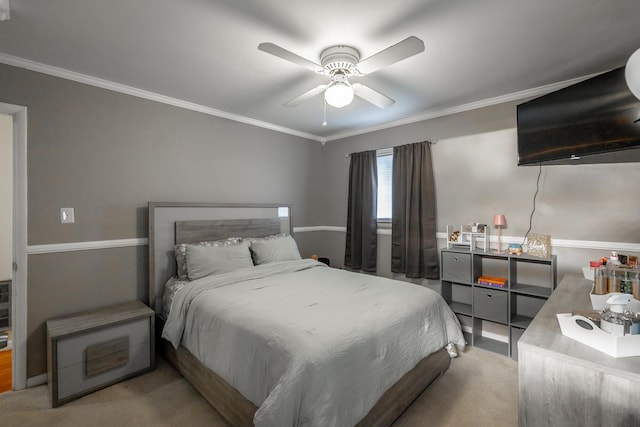 bedroom featuring ornamental molding, ceiling fan, and carpet