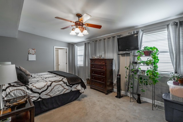 bedroom featuring vaulted ceiling, light colored carpet, and ceiling fan