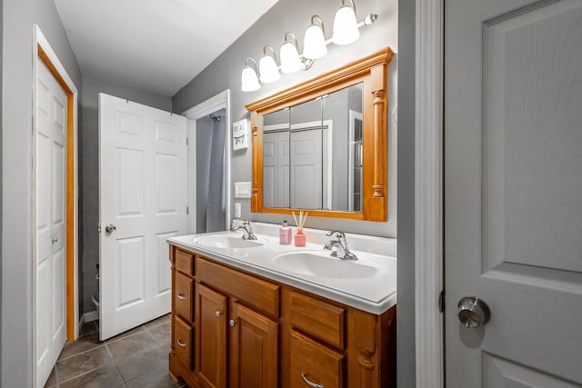 bathroom with vanity, tile patterned flooring, and toilet