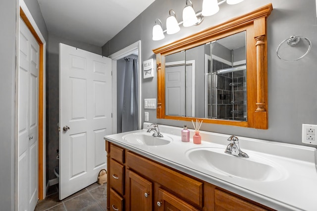 bathroom featuring vanity, a shower with door, and tile patterned floors