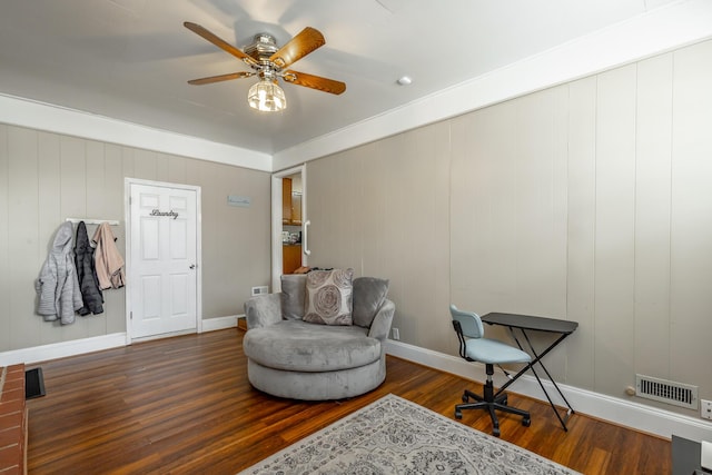 sitting room with dark hardwood / wood-style floors and ceiling fan