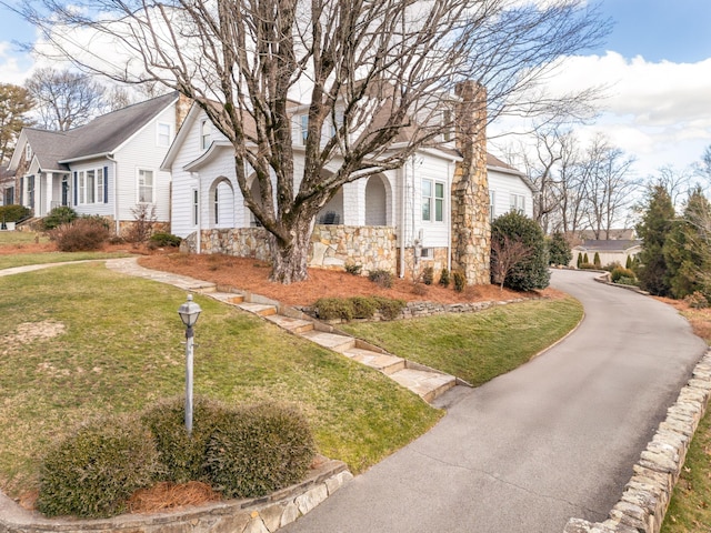 view of side of home featuring a lawn