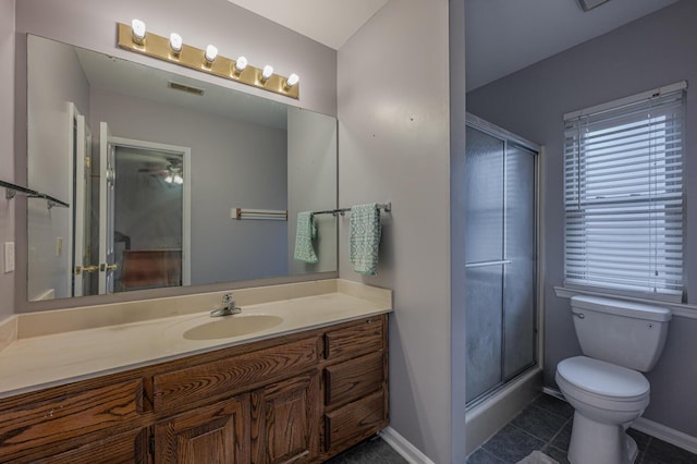 bathroom featuring vanity, toilet, and an enclosed shower