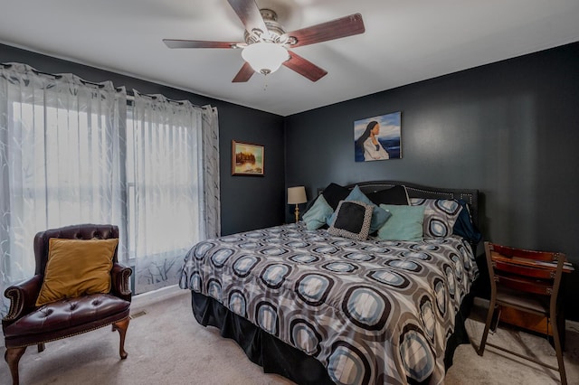 bedroom with light carpet and ceiling fan