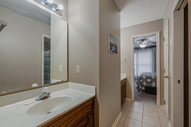 bathroom featuring vanity, tile patterned flooring, and a textured ceiling