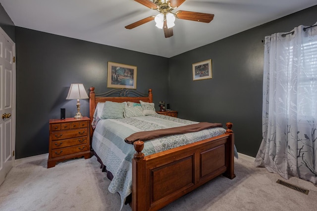 bedroom with light carpet and ceiling fan