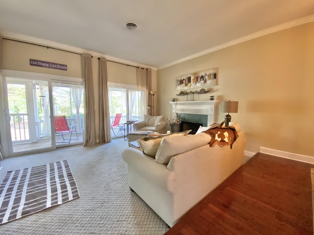 carpeted living room featuring ornamental molding