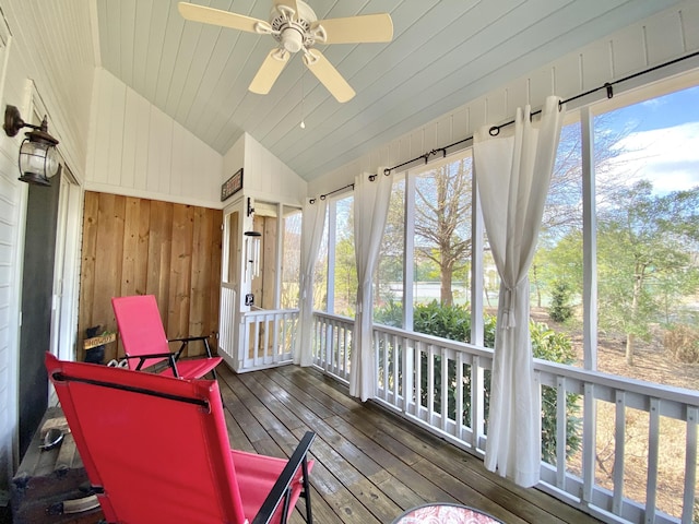 sunroom featuring ceiling fan and vaulted ceiling