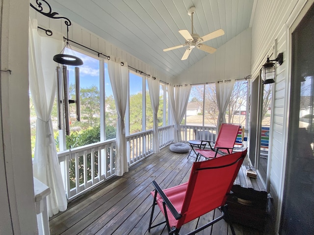 sunroom / solarium with vaulted ceiling, wooden ceiling, and ceiling fan