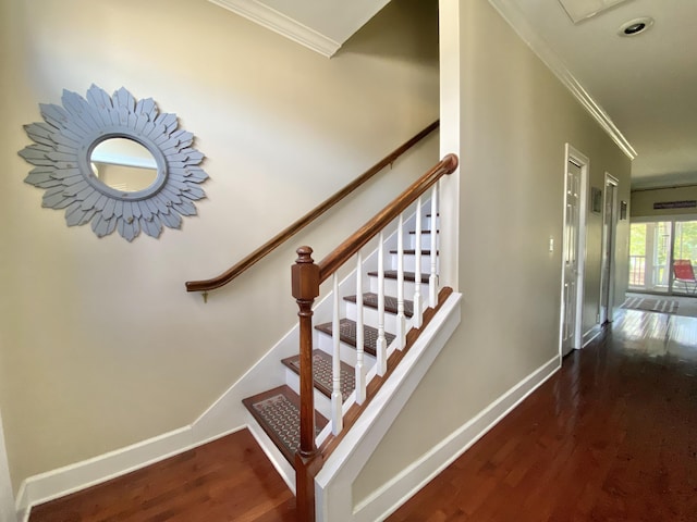 stairway with crown molding and hardwood / wood-style floors