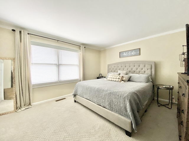 bedroom with crown molding and carpet