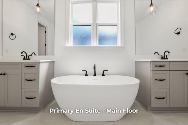 bathroom with vanity, a bathtub, and tile patterned floors