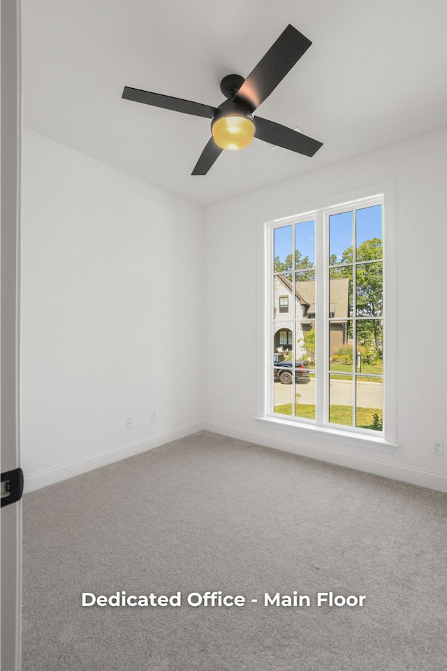 empty room featuring ceiling fan and carpet