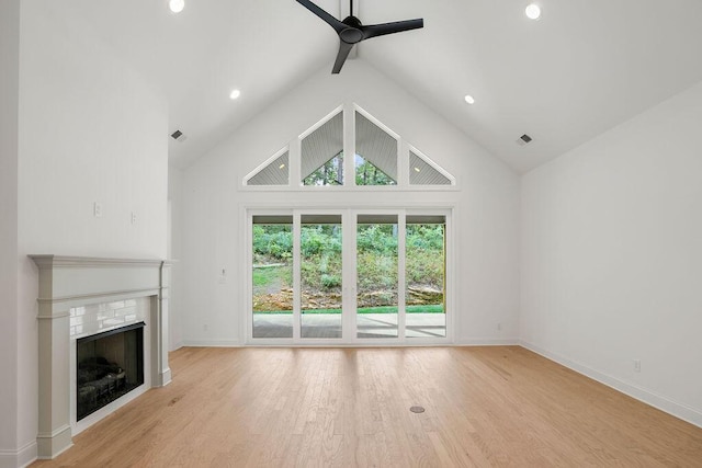 unfurnished living room with high vaulted ceiling, beamed ceiling, light hardwood / wood-style floors, and ceiling fan