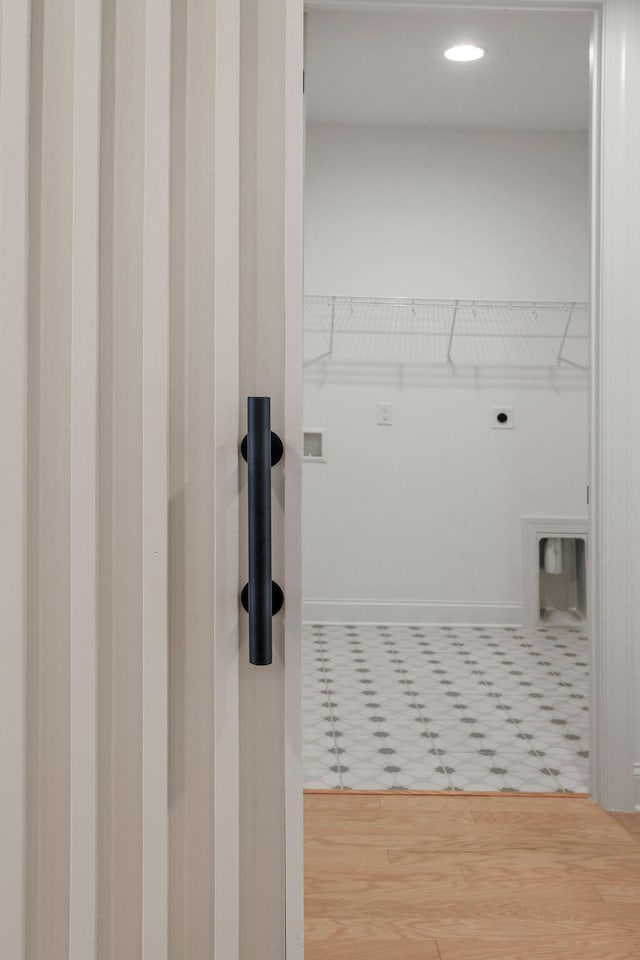 washroom with electric dryer hookup and hardwood / wood-style floors