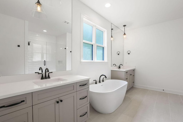 bathroom featuring vanity and independent shower and bath