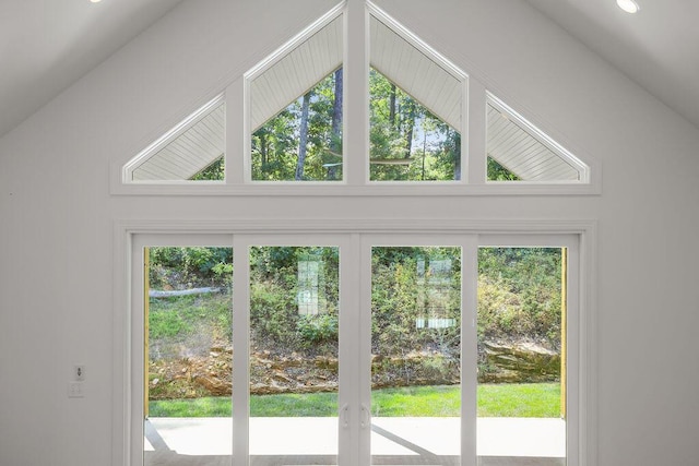 doorway to outside featuring high vaulted ceiling