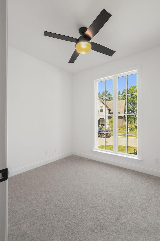 spare room with carpet floors and ceiling fan