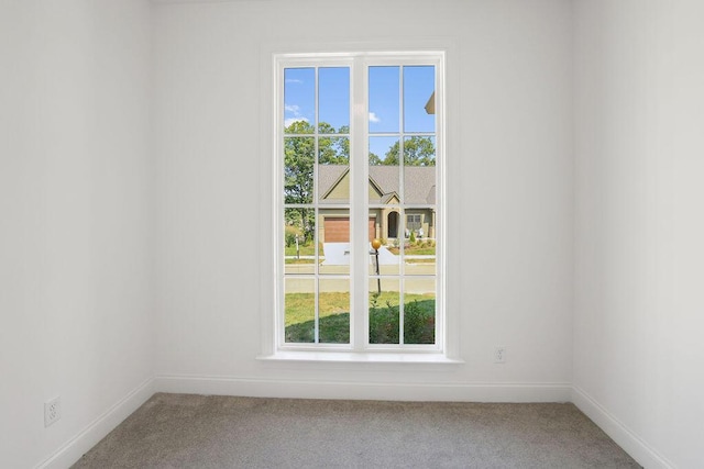 carpeted empty room with a healthy amount of sunlight