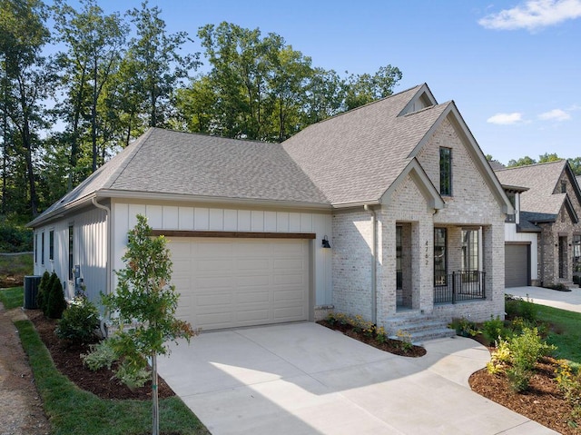 view of front facade with a garage, a porch, and cooling unit