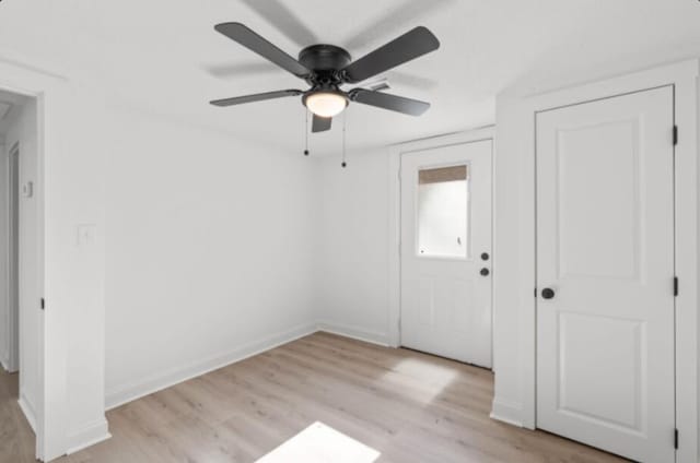 foyer entrance with ceiling fan and light hardwood / wood-style floors