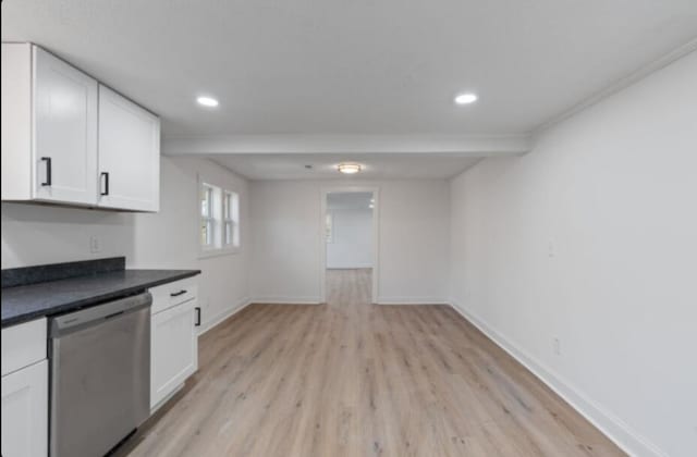 kitchen featuring stainless steel dishwasher, white cabinets, and light hardwood / wood-style flooring