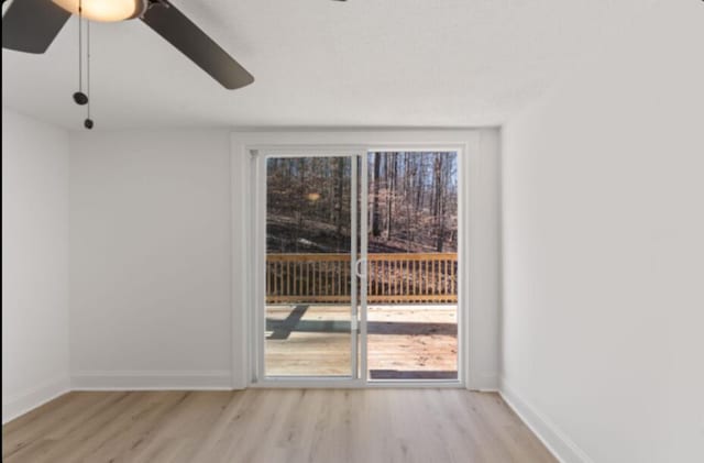 unfurnished room featuring ceiling fan and light wood-type flooring