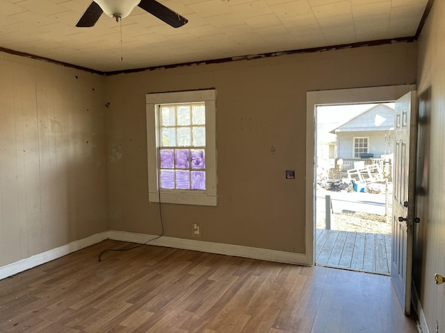 unfurnished room featuring crown molding, hardwood / wood-style flooring, and ceiling fan