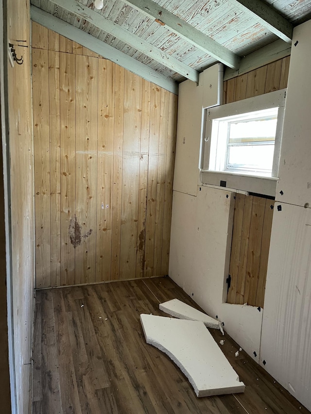 spare room featuring dark hardwood / wood-style flooring, vaulted ceiling with beams, wood ceiling, and wooden walls