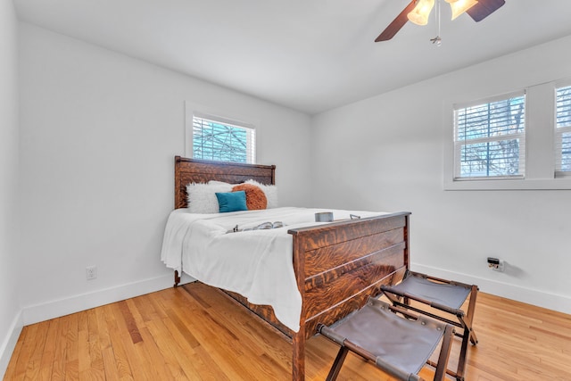 bedroom featuring ceiling fan, wood finished floors, and baseboards