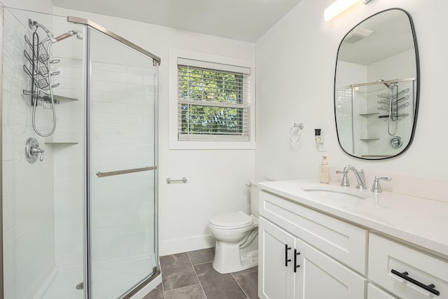 bathroom with a stall shower, vanity, and toilet