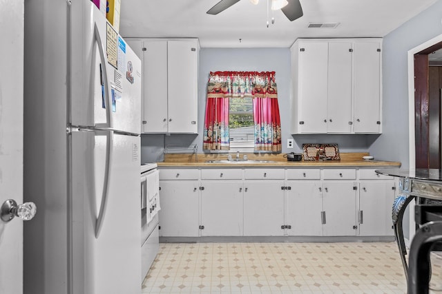 kitchen featuring sink, white appliances, white cabinets, and ceiling fan