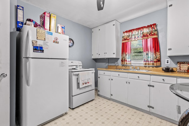 kitchen featuring white cabinetry, sink, and white appliances