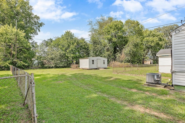 view of yard featuring central air condition unit and a storage unit