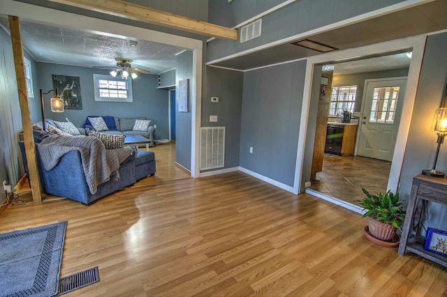 living room with hardwood / wood-style flooring and ceiling fan