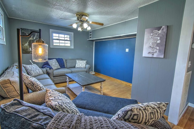 living room featuring wood-type flooring and ceiling fan