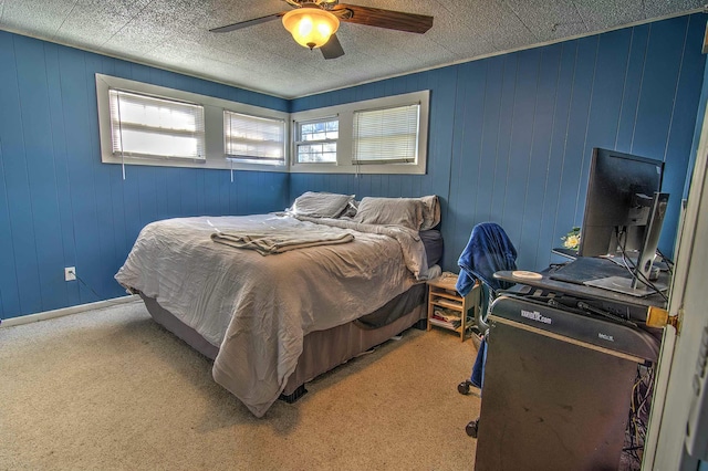 carpeted bedroom with wooden walls and ceiling fan