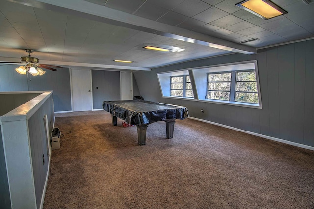 rec room featuring wooden walls, beamed ceiling, carpet floors, pool table, and ceiling fan