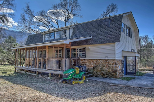 view of front facade with a playground and covered porch