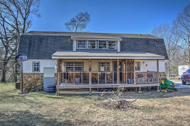 rear view of house with a porch, cooling unit, and a lawn