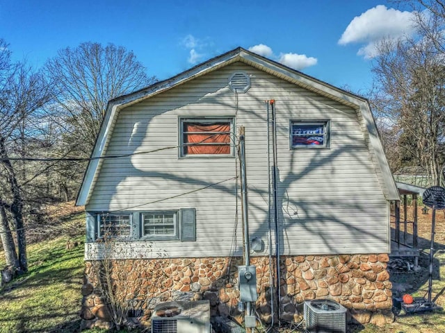 view of side of home with central AC