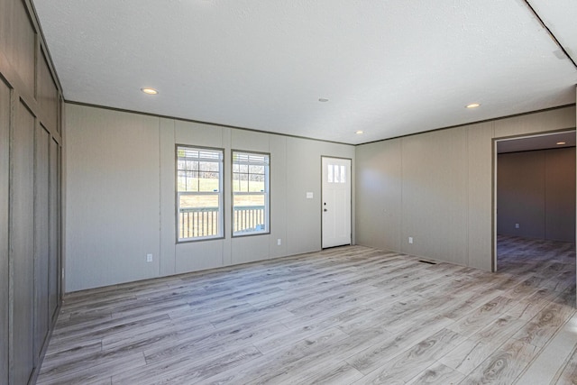 interior space with light hardwood / wood-style floors and a textured ceiling