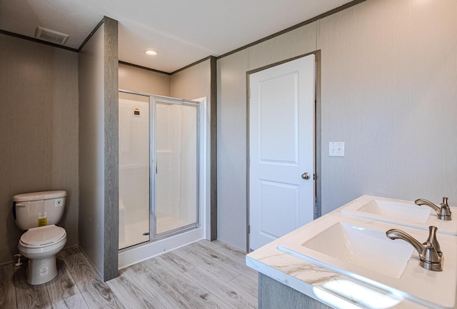 bathroom with vanity, hardwood / wood-style floors, toilet, and walk in shower