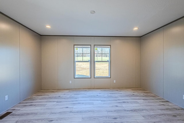 spare room with light hardwood / wood-style floors