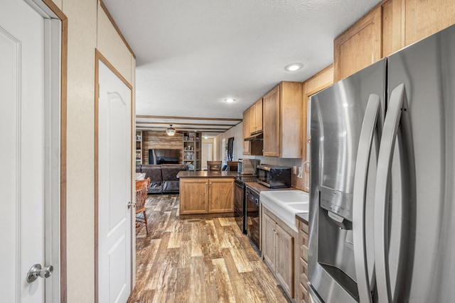 kitchen with light hardwood / wood-style flooring, dishwasher, ceiling fan, stainless steel fridge with ice dispenser, and kitchen peninsula